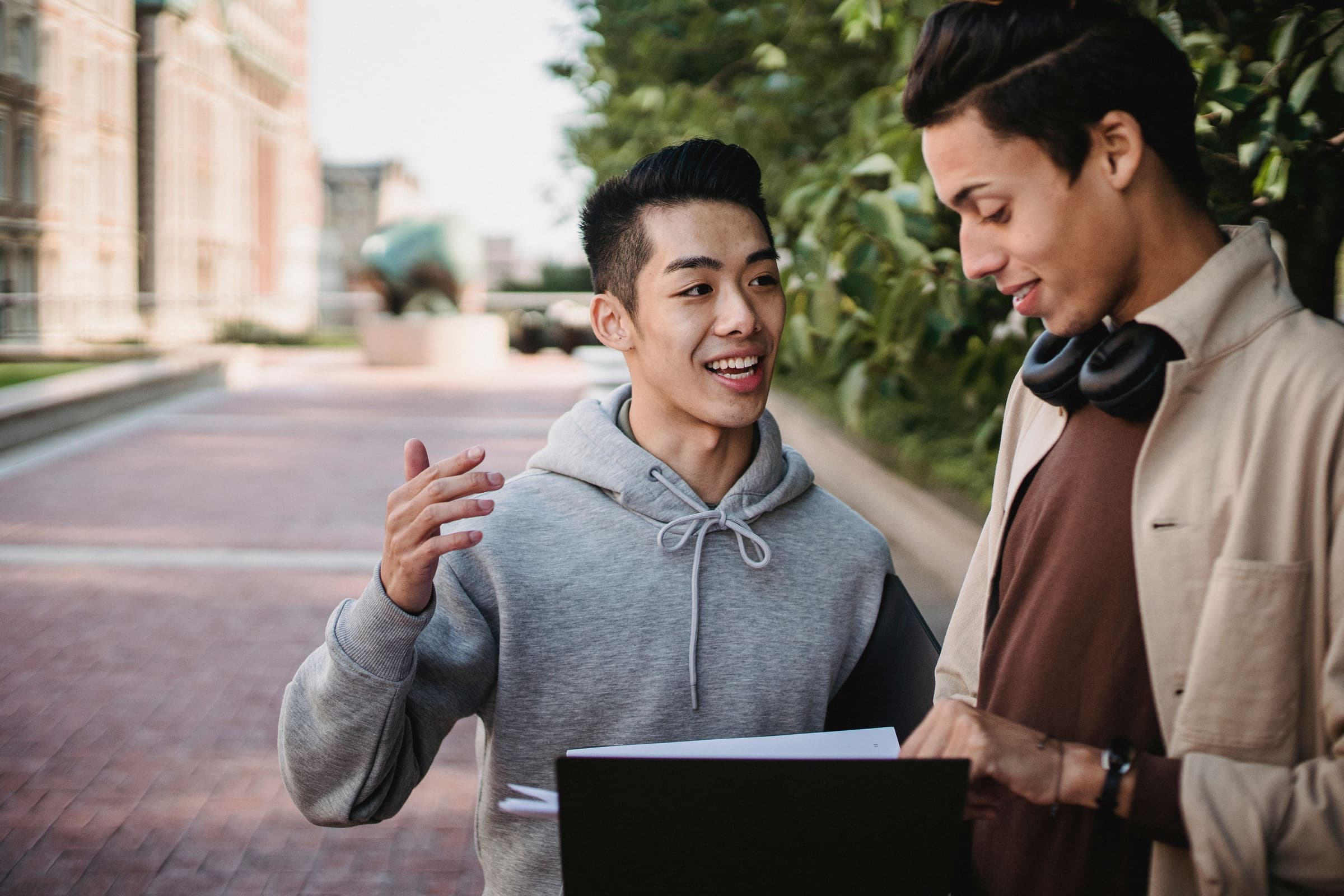Two students talking together outside a university